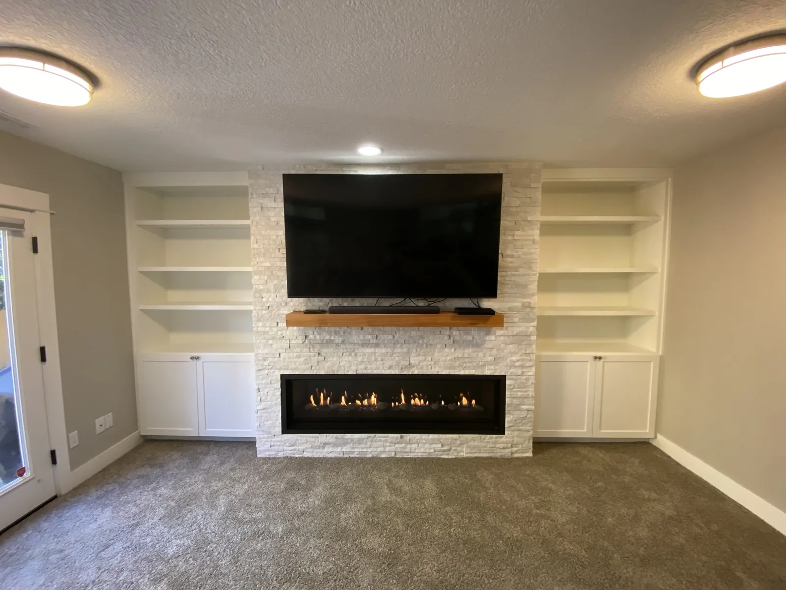 Built-ins around a linear fireplace