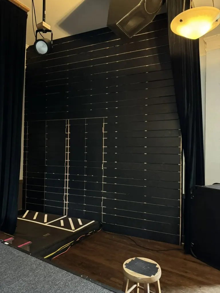 Helmholtz resonator wall for sound control beside the stage at Polaris Hall, Portland