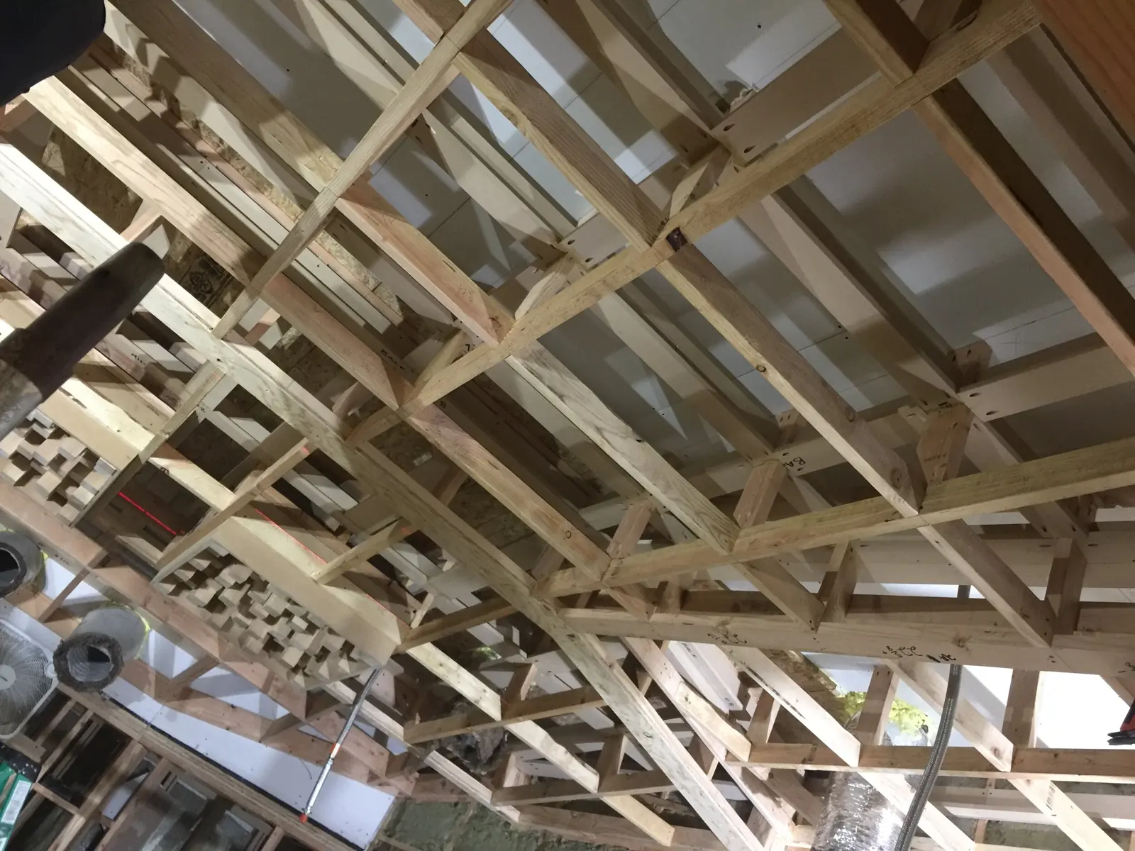 Intricate three layer ceiling framing for holding staggered layers of insulation with ascending density profiles.